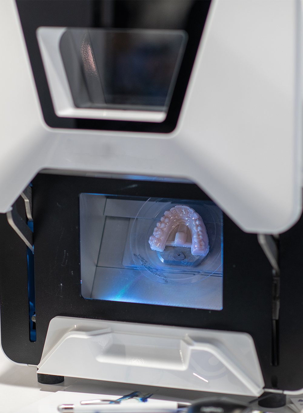 3D printed dental restoration model in Burbank, CA Digital dental arch model curing inside a 3D printer at Ultra Dynamics milling lab